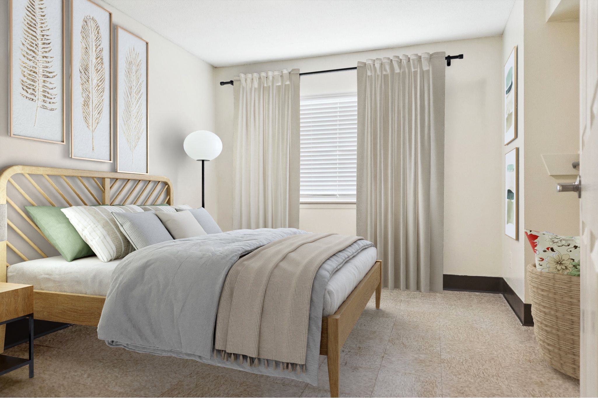 A bedroom with a bed, nightstand, and pictures on the wall.